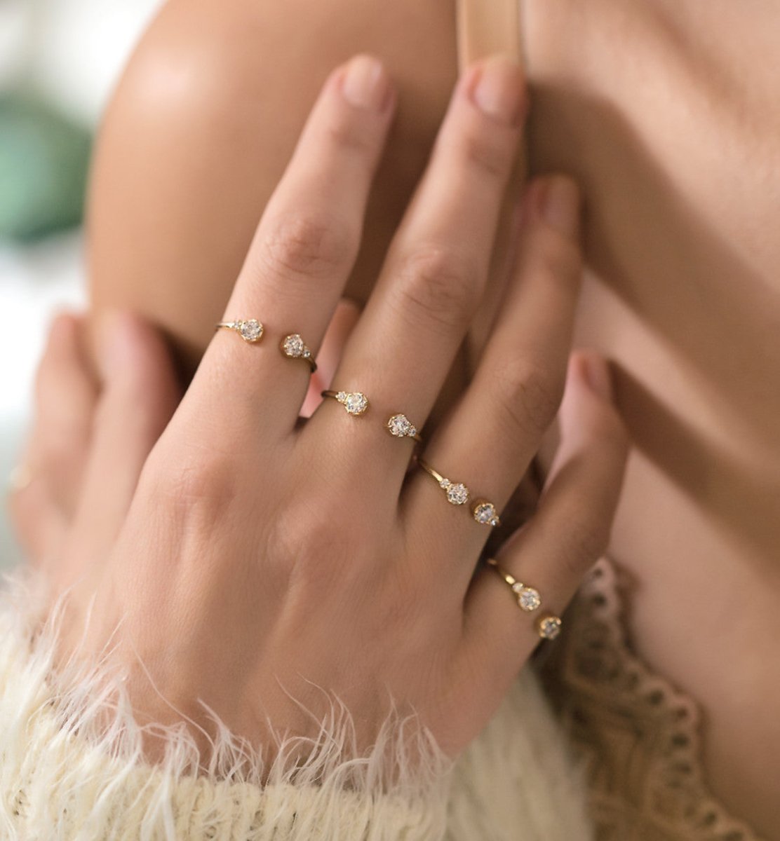 Gold vermeil open cuff ring with clear zirconia stones, styled in a ring stack on a hand