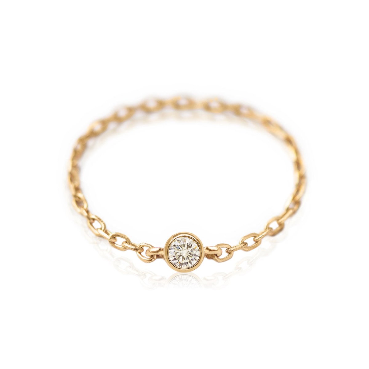 14K gold delicate chain ring with a single bezel-set round diamond, on a white background