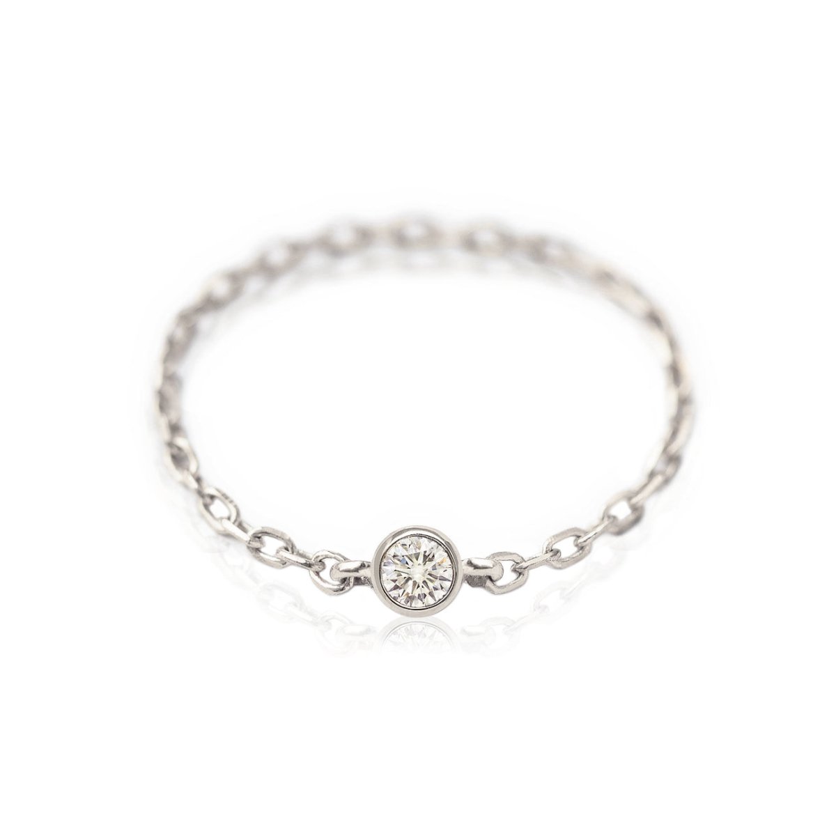 14K white gold diamond chain ring with a single bezel-set round diamond on a delicate chain band, on a white background