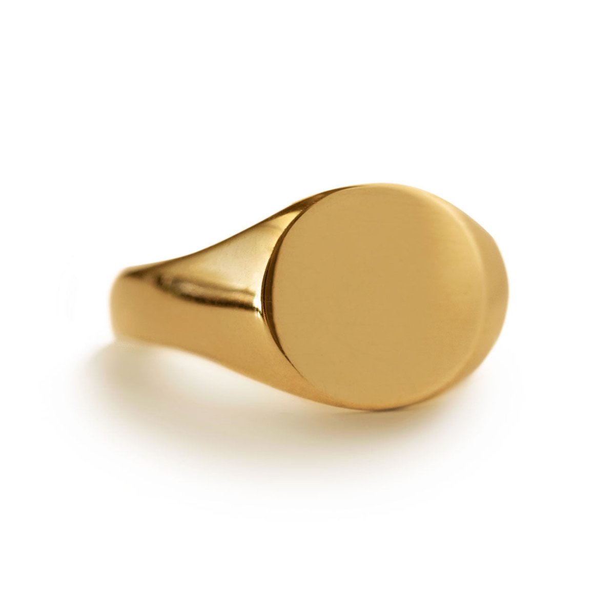 Gold vermeil oval signet ring with a plain face, on a white background