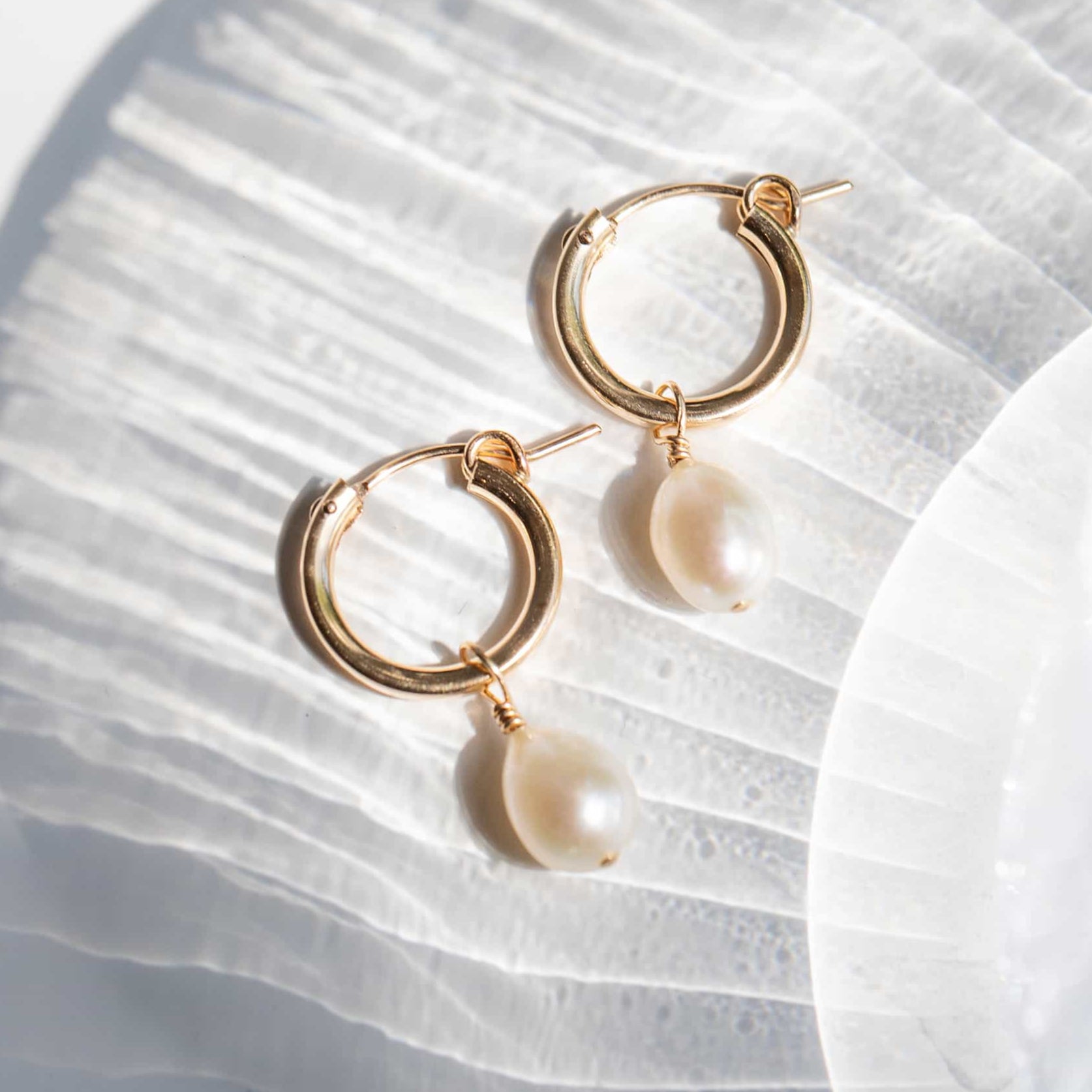 Gold hoop earrings with freshwater pearl drops