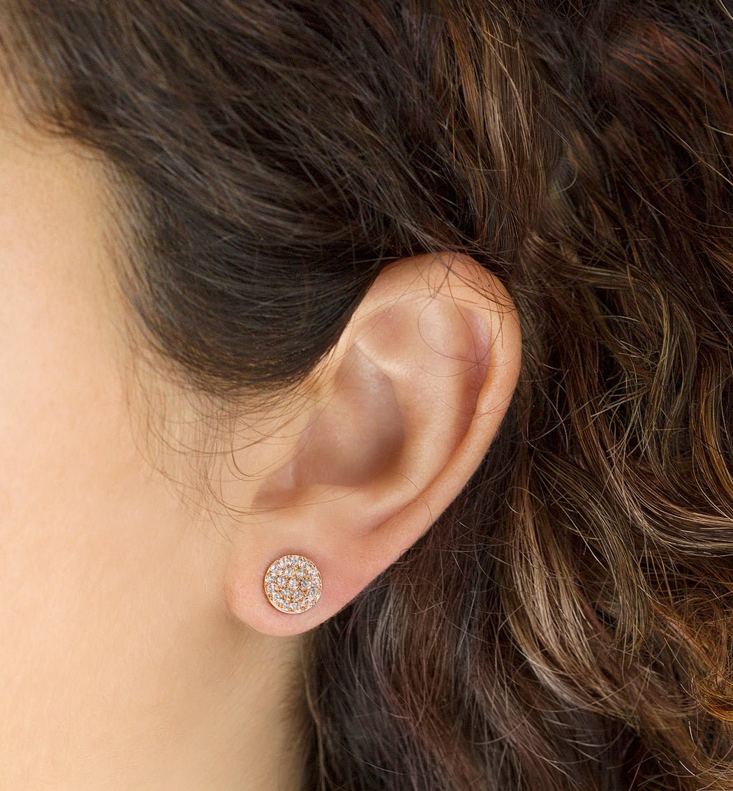 Rose gold vermeil pavé round stud with white zirconia, shown on a model's lobe