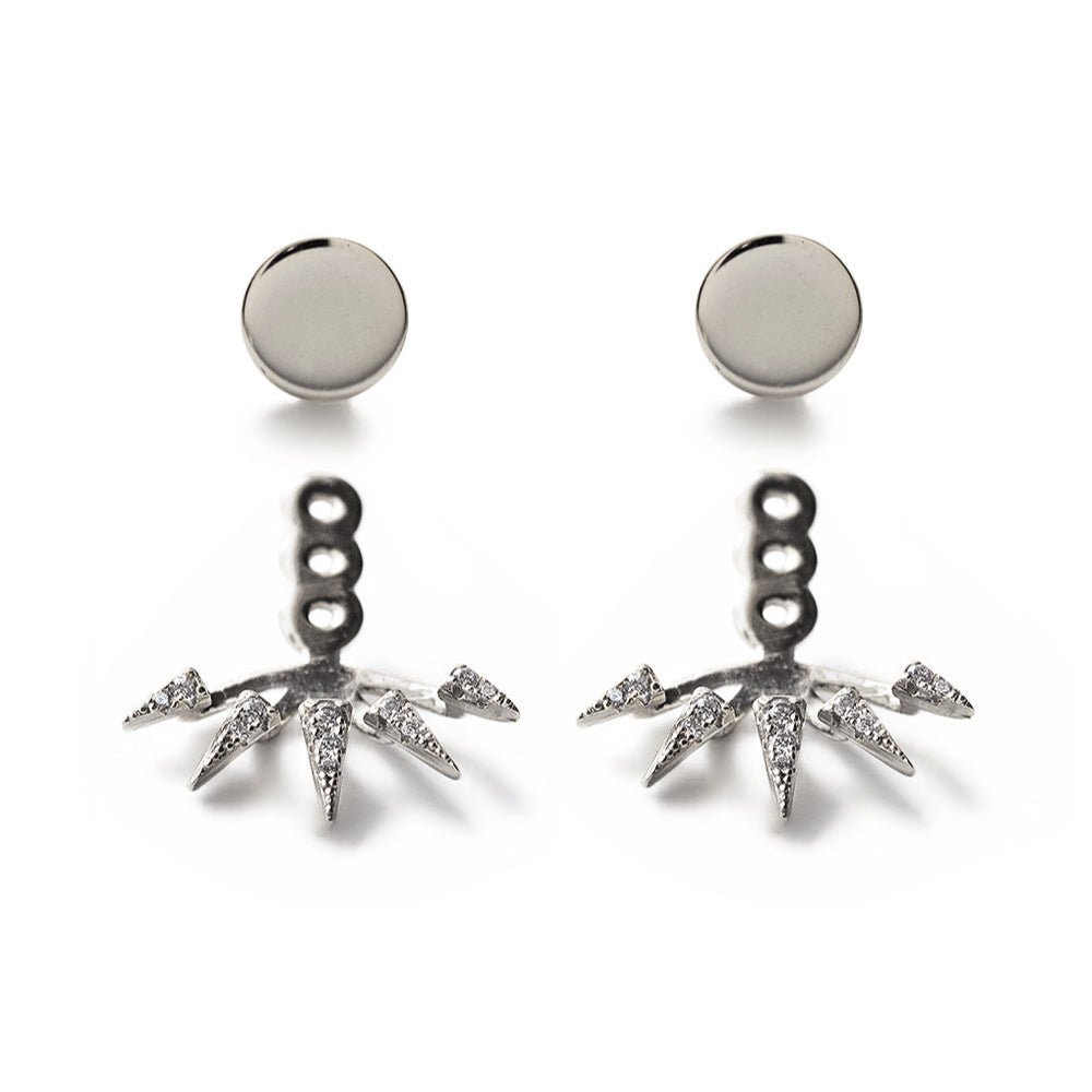 Sterling silver spike ear jacket earrings with white zirconia, round studs above, on a white background
