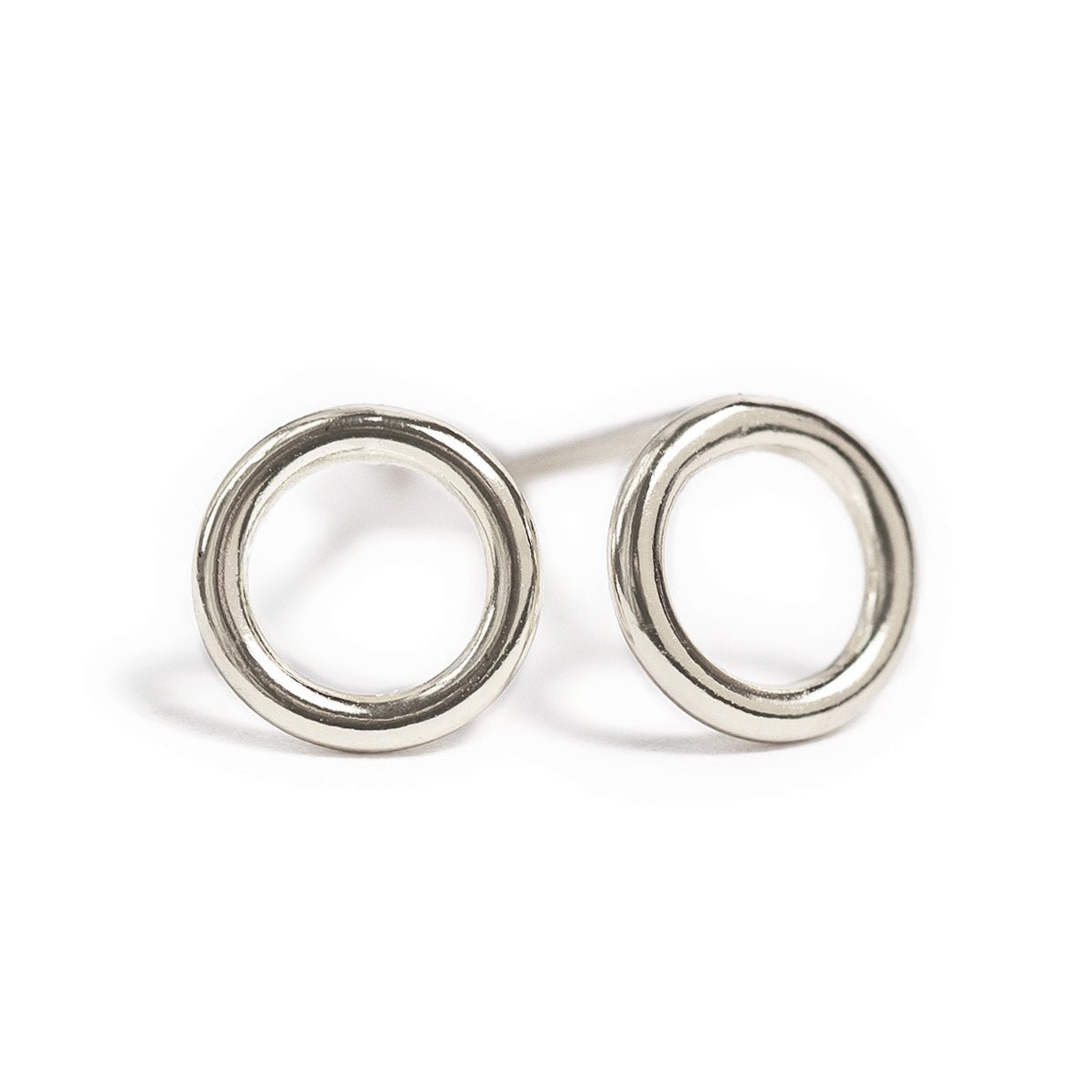 Pair of sterling silver open circle stud earrings on a white background