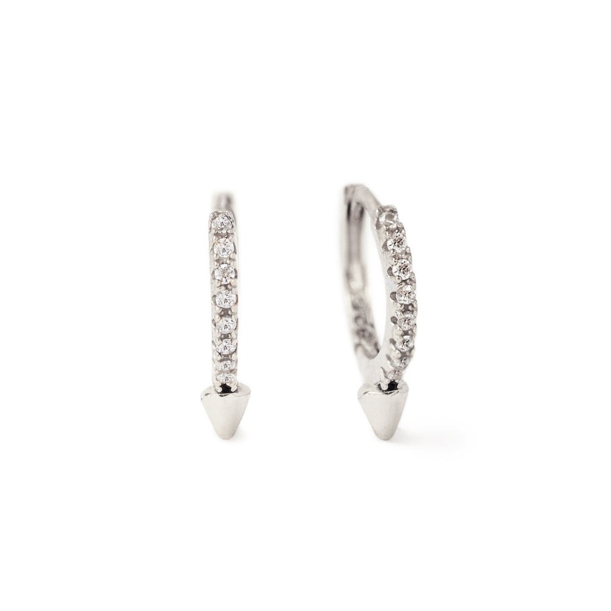 Sterling silver pavé spike huggie hoops with clear stones and a cone drop, on a white background