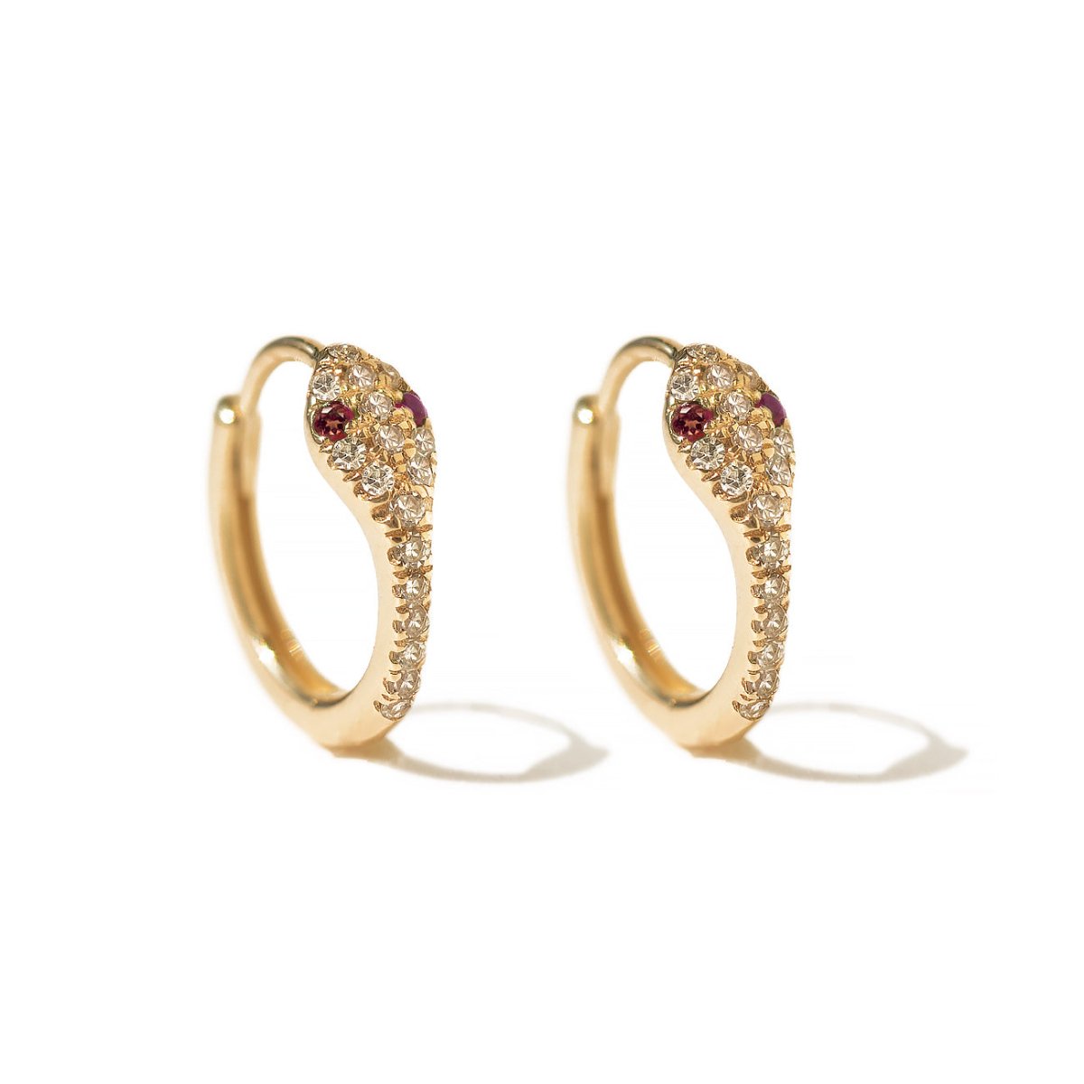 Pair of 14K gold snake huggie hoops paved with natural diamonds and pink eye stones, on white background