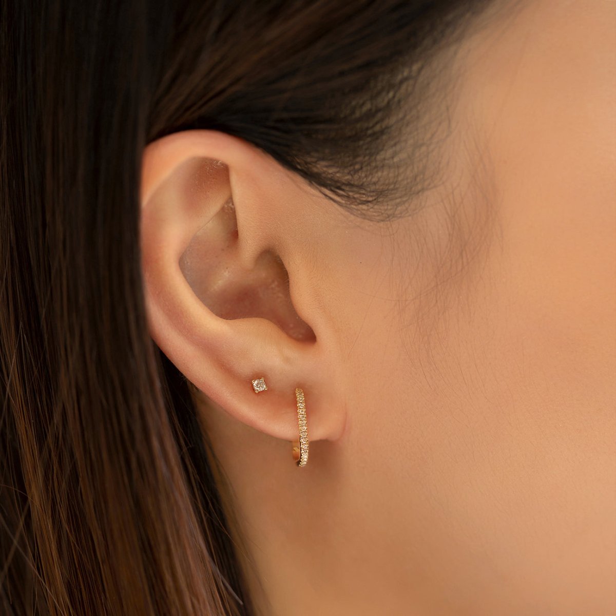 14K gold diamond oval hoop with a diamond stud above, shown on a model's ear