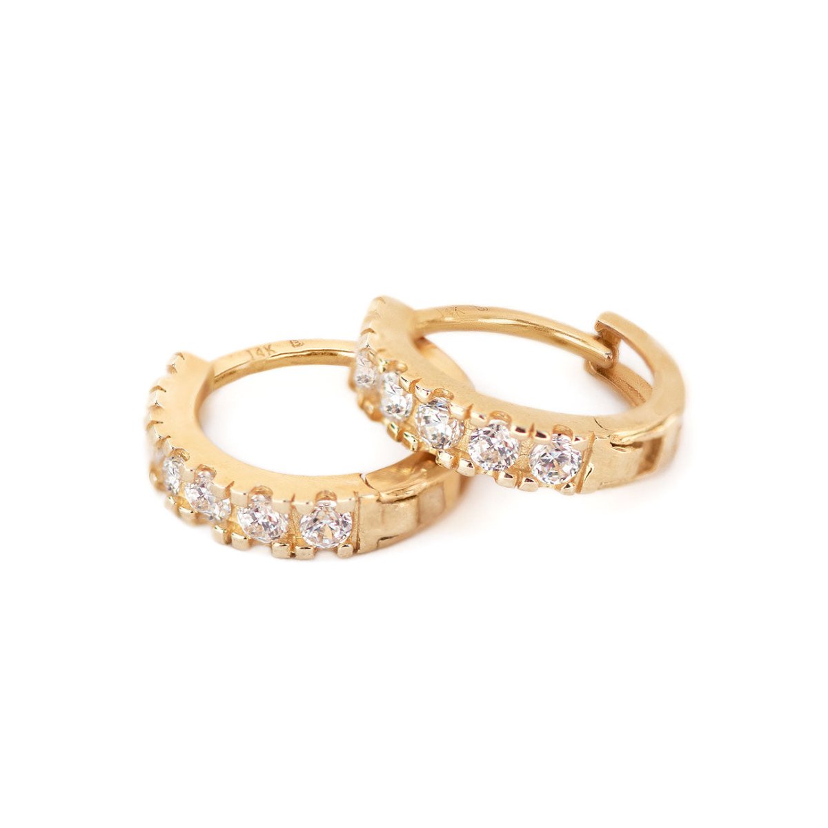 Pair of 14K gold diamond pave huggie hoops shown loose on a white background