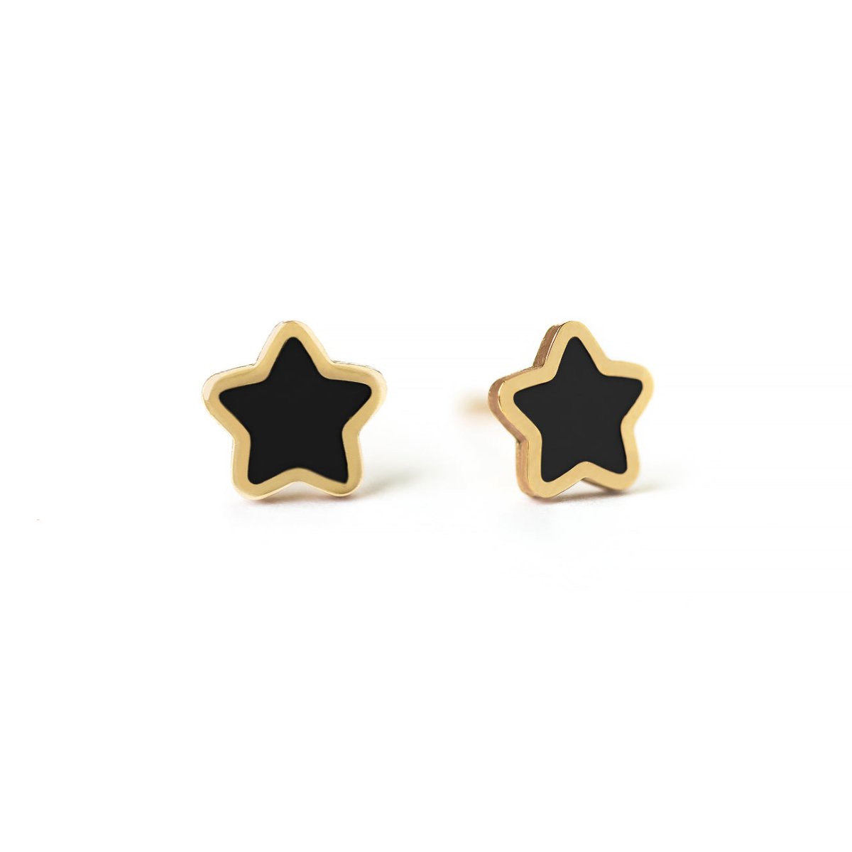 Pair of 14K gold star studs with black onyx centers, on a white background