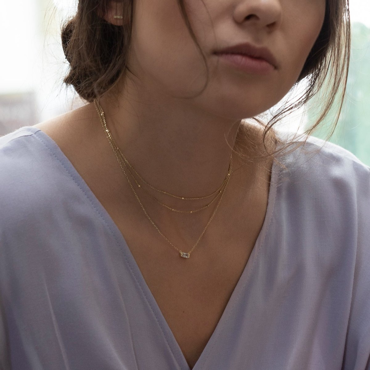Gold vermeil double-layered beaded choker layered in a necklace stack, shown on a model
