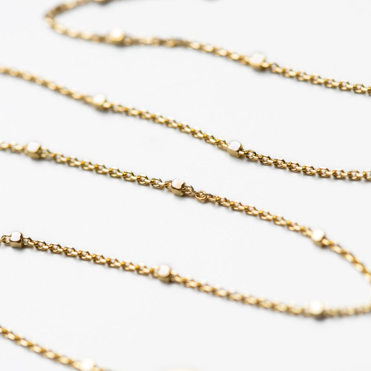 Gold vermeil double-layered beaded choker, close-up detail on a white background