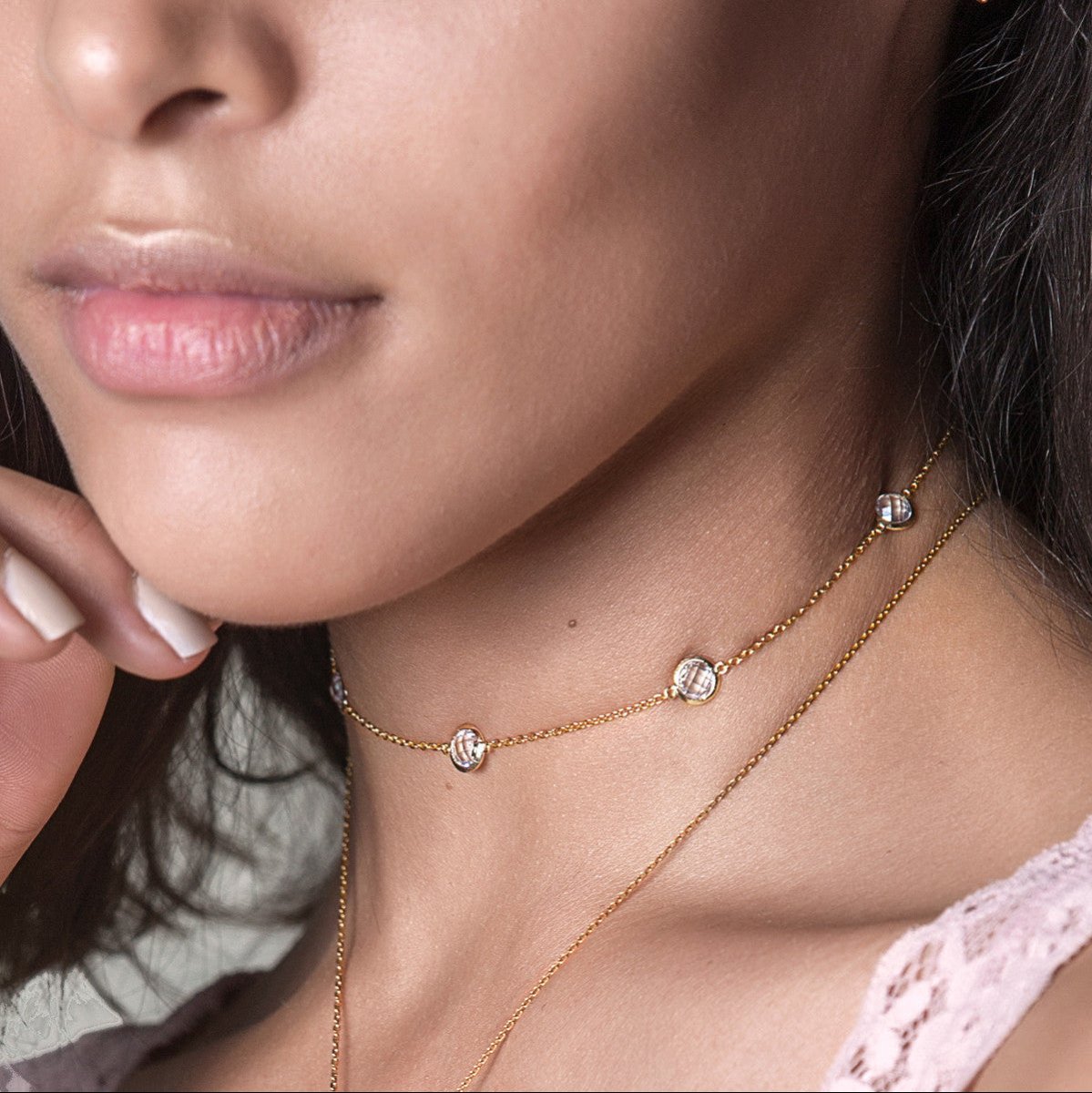 Gold vermeil white zirconia station choker shown layered on a model's neckline