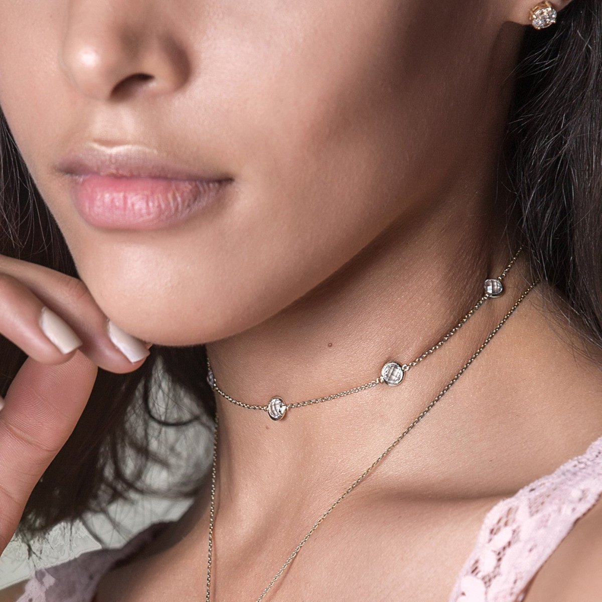 Sterling silver white zirconia station choker shown on a model's neckline
