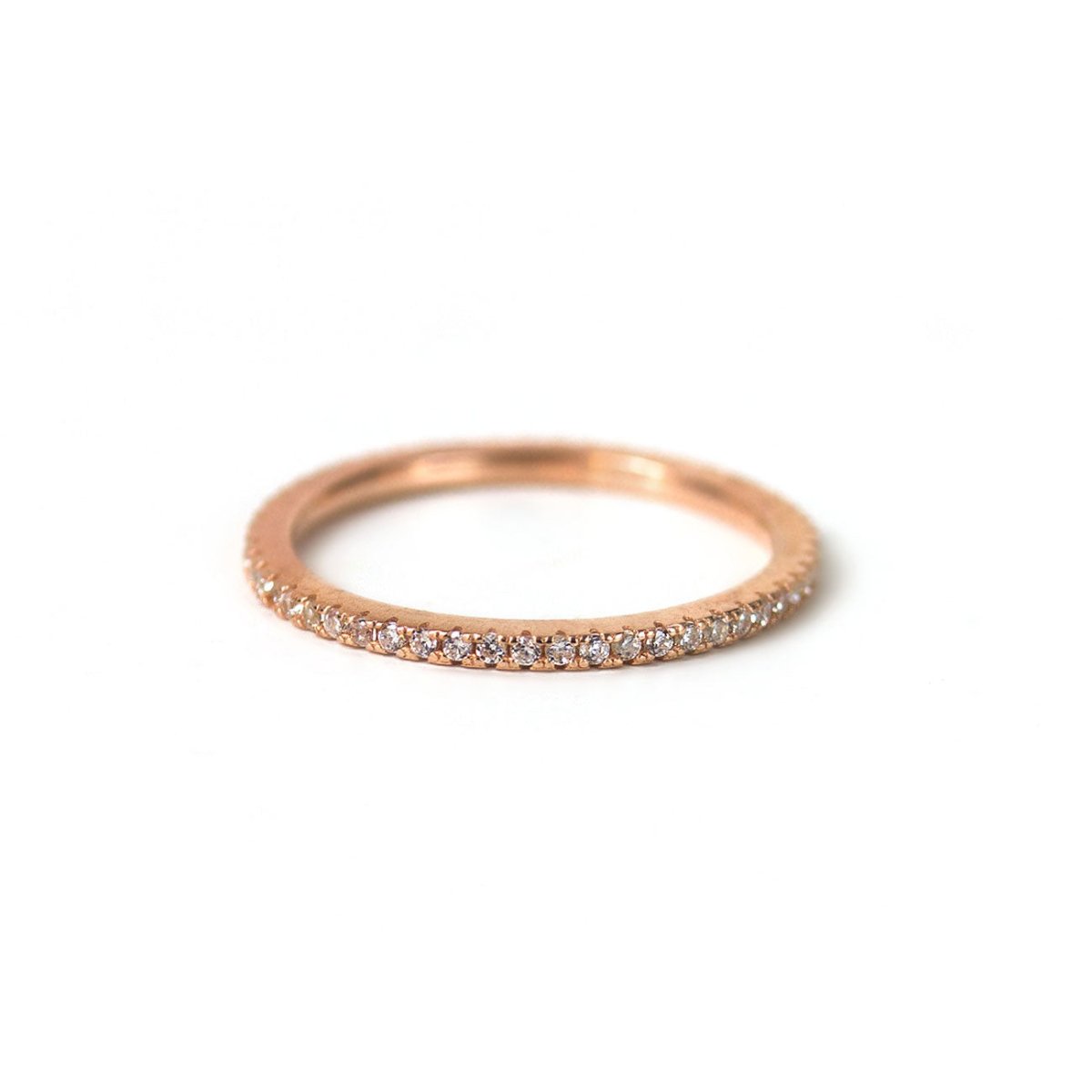Rose gold vermeil pavé eternity ring set with white zirconia, on a white background