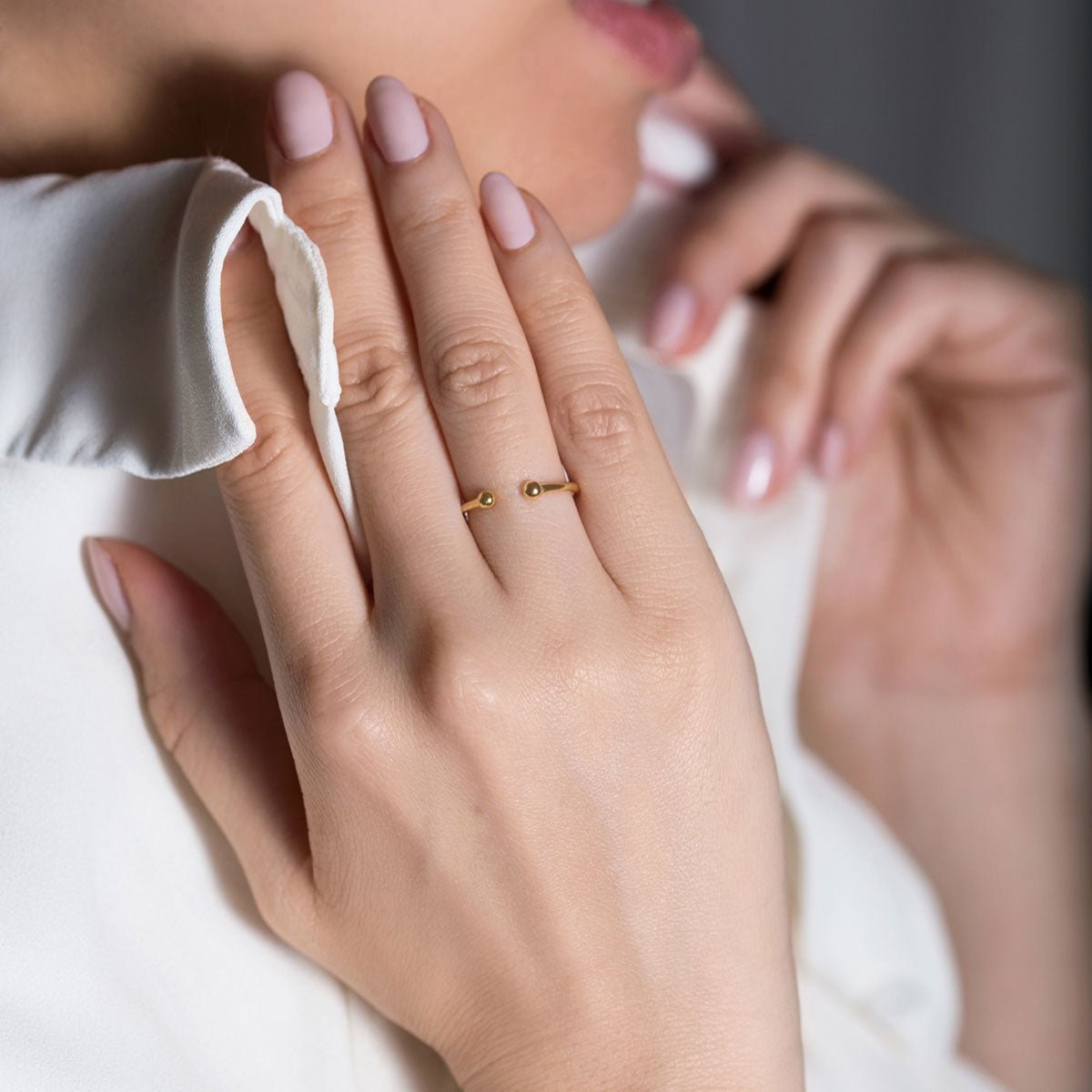 Gold vermeil open ball-end ring, shown on a model's finger