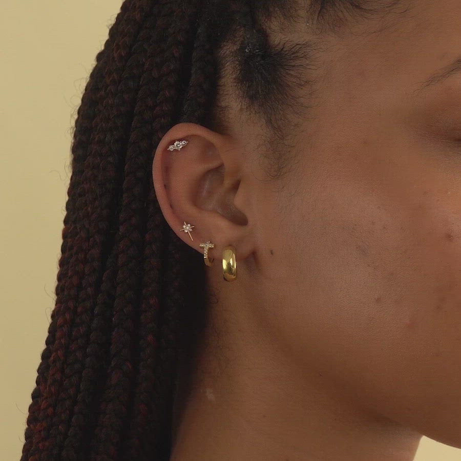 Video of woman's ear featuring 14K Solid Gold Trio Bar Pave Studs paired with gold hoop and huggie 